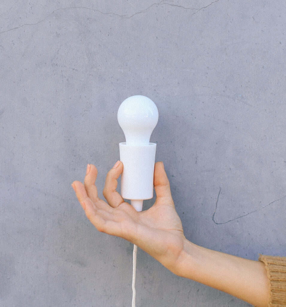 person holding a light bulb