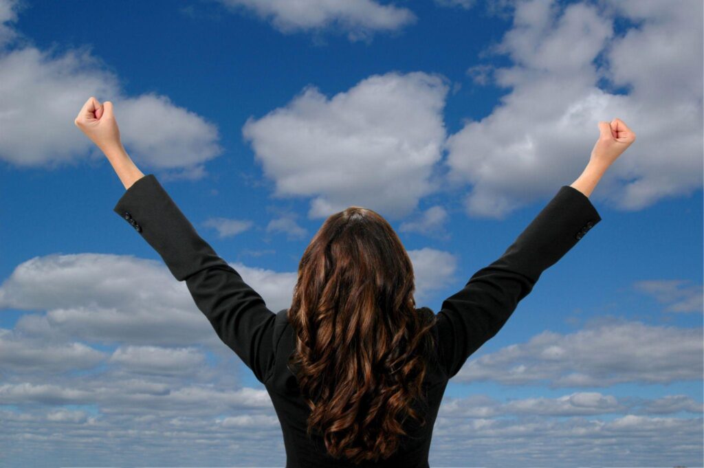 woman with hands raised in celebration