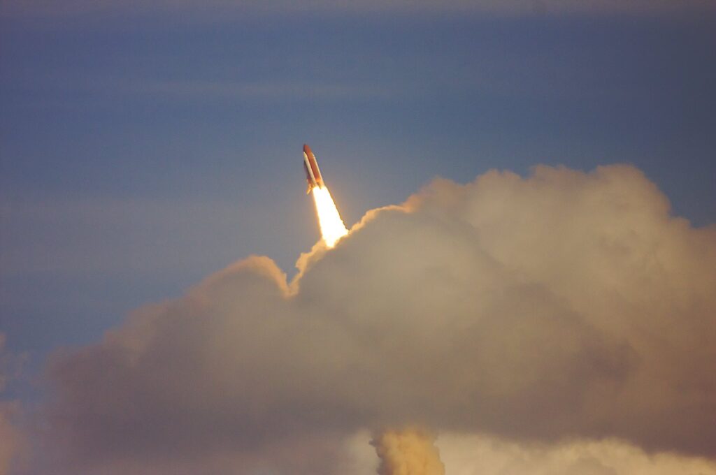 space shuttle launching with clouds of smoke