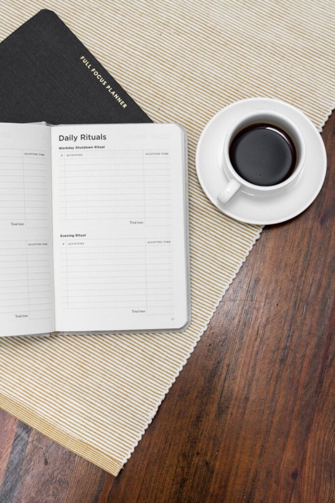planner with cup of coffee on right side