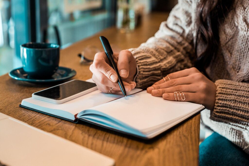 woman writing in a journal