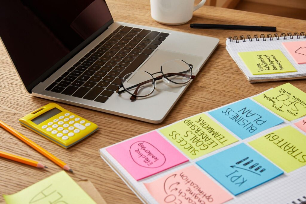 laptop with glasses, calculator, book