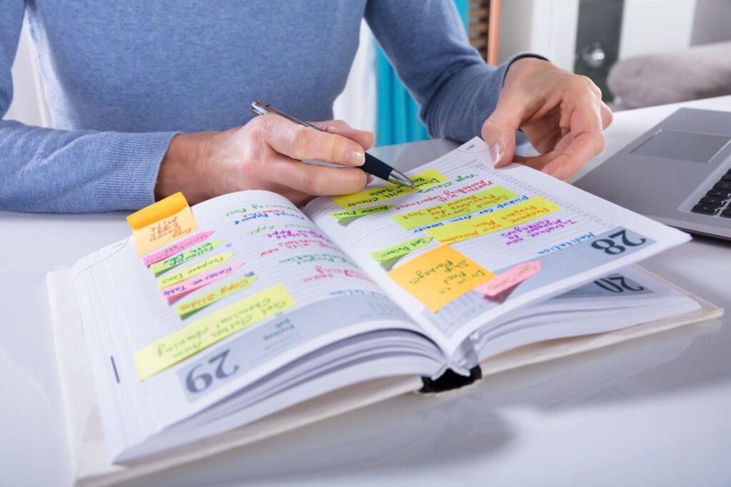 woman writing in a planner