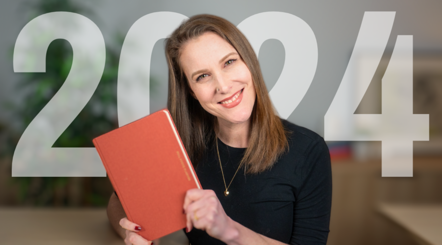Rachel Harrison Sund's thumbnail image for blog post "A Millionaire's Plan to Living Your Best Year Ever." Image shows Rachel in a black top posing with a red planner. Text overlay reads "2024."